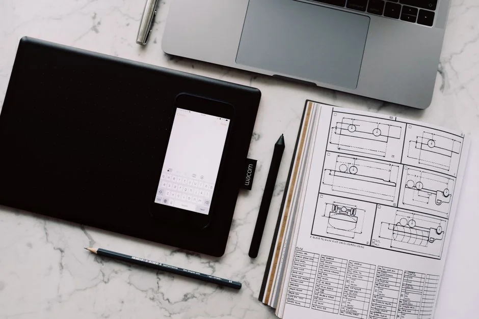 Dual monitors on a desk, showcasing web design in a modern office setting.